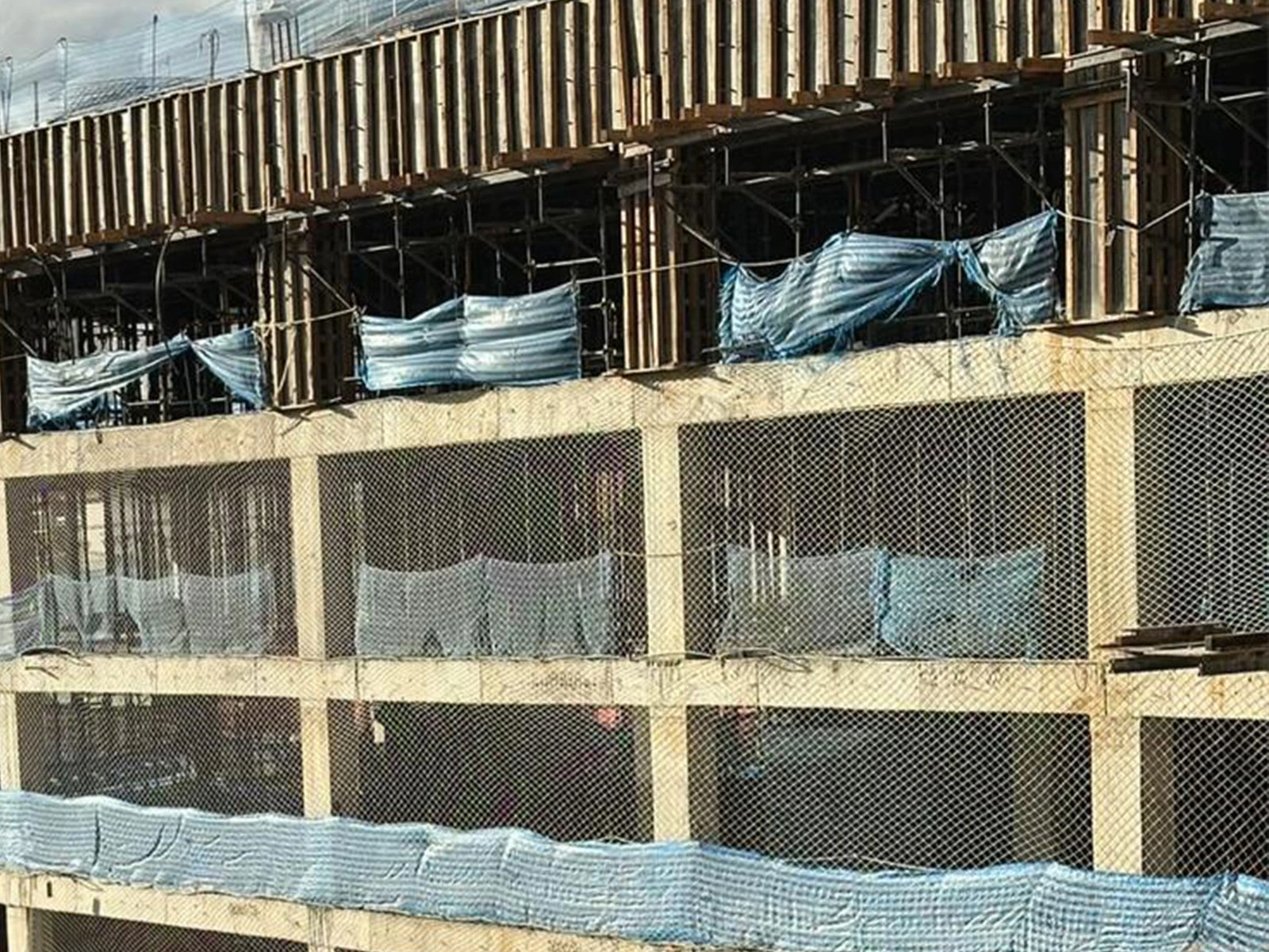 Sistema de proteção piso a piso com telas reforçadas instalado na fachada de um edifício, garantindo o fechamento total do vão entre pavimentos.